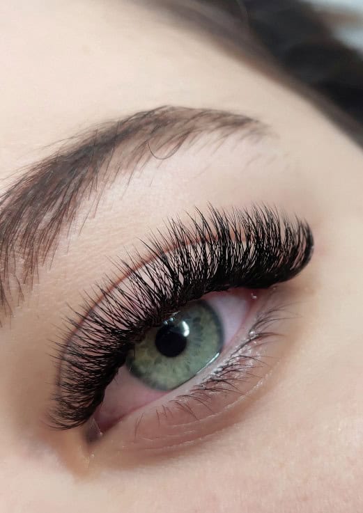 A close up of an eye with eyelash extensions