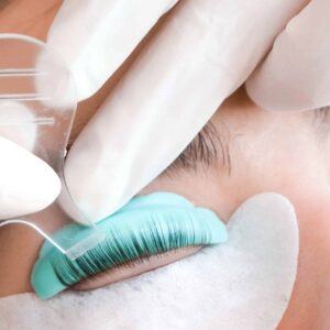 A close up of a lash lift and tint treatment using tools to work on the lashes