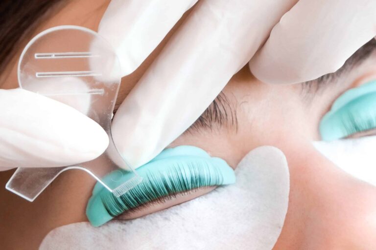 A close up of a lash lift and tint treatment using tools to work on the lashes